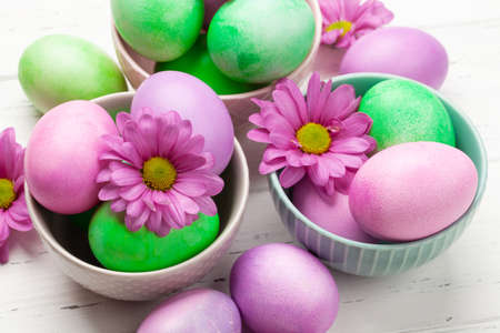 Easter greeting card with colorful easter eggs and flowers
