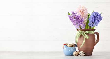 Easter greeting card with easter eggs and hyacinth flowers bouquet. With space for your greetings