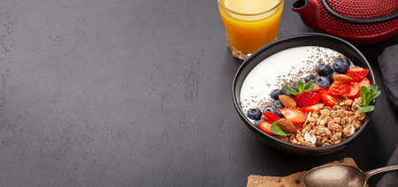 Healthy breakfast with bowl of granola, yogurt and fresh berries. Fitness protein meal. With copy spaceの写真素材