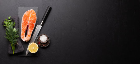 Fresh raw salmon cooking. Fish steak with herbs and spices. Top view flat lay with copy spaceの写真素材