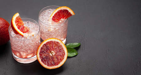 Fresh citrus lemonade with blood oranges and crushed ice. With copy spaceの写真素材