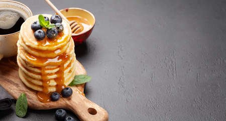 Breakfast with pancakes and espresso coffee. Homemade american pancakes with berries and honey. With copy spaceの写真素材