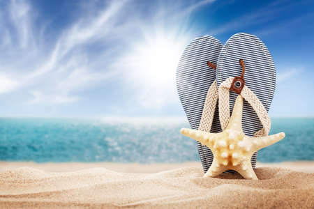 Flip flops on sunny sea beach with copy space. Summer sea vacation and travel conceptの写真素材