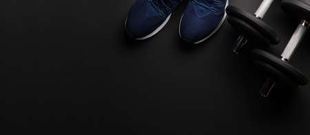 Sneakers and dumbbells. Sport, fitness and healthy lifestyle background. Top view flat lay with copy spaceの写真素材