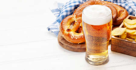 Lager beer mug and fresh baked homemade pretzel with sea salt. Classic beer snack. With copy space