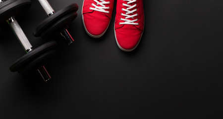 Sneakers and dumbbells. Sport, fitness and healthy lifestyle background. Top view flat lay with copy spaceの写真素材