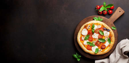 Italian pizza with tomatoes, mozzarella and basil. Top view flat lay with space for your textの写真素材