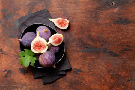 Ripe sweet figs in bowl. Top view flat lay with copy spaceの写真素材