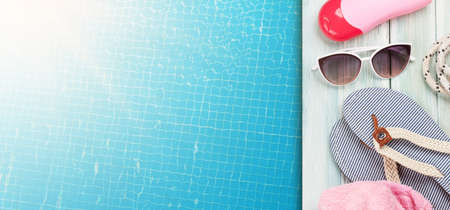 Pool and beach items and water surface of swimming pool. Travel and vacation concept. Top view flat...