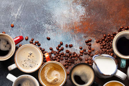Many cups of coffee on stone table. Top view flat lay with copy space