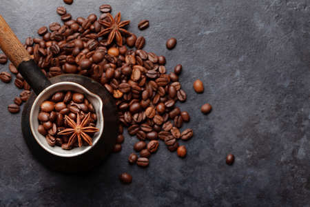 Roasted coffee beans in Turkish jezve. Top view flat lay with copy spaceの写真素材