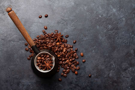 Roasted coffee beans and Turkish jezve. Top view flat lay with copy spaceの写真素材