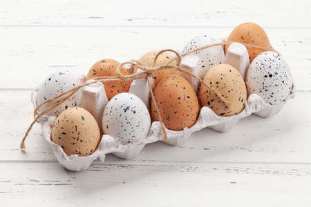 Chicken eggs pack on wooden table. Easter eggs