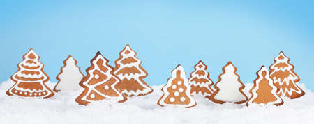 Christmas greeting card with homemade gingerbread trees in snowの写真素材