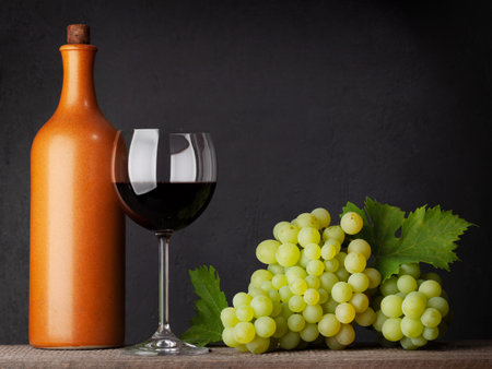 White grape, bottle and red wine glass. With copy spaceの写真素材
