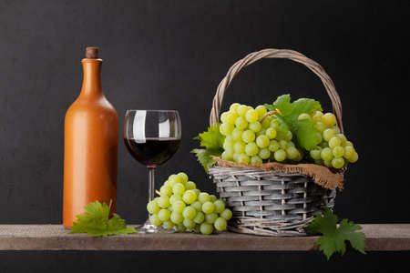 White grape, wine bottle and red wine glassの写真素材