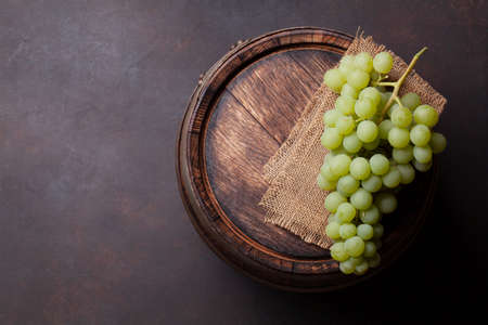 White grape on old wooden wine barrel. Top view flat lay with copy spaceの写真素材