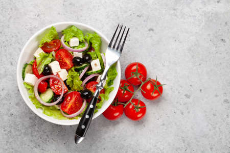 Classic greek salad with fresh garden vegetables. Top view flat lay with copy spaceの写真素材