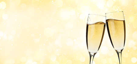 Christmas or Happy Birthday greeting card with champagne glasses and bokeh background. Holiday card with copy spaceの写真素材
