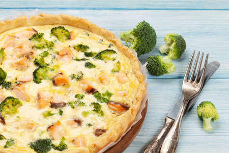 Homemade fish pie. Open faced salmon and broccoli pie on kitchen tableの写真素材