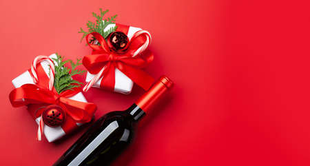 Christmas gift boxes and wine bottle. Top view flat lay with copy spaceの写真素材