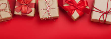 Christmas or Valentine's day gift boxes frame on red background. Top view flat layの写真素材