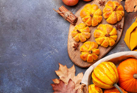 Homemade pumpkin look muffins and various pumpkins. Top view flat lay with copy space