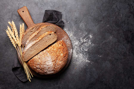 Fresh homemade bread on stone table. Top view flat lay with copy space