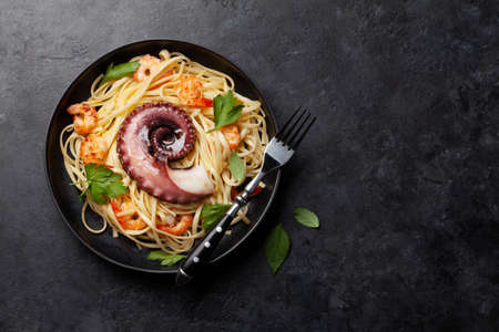 Seafood pasta with octopus and shrimps. Top view flat lay with copy spaceの写真素材