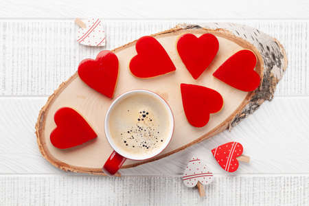 Heart shaped sweet cookies and coffee cup. Valentines Day greeting card. Top view flat lay
