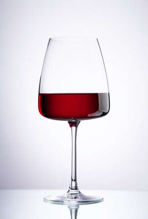 Red wine glass over gray backgroundの写真素材