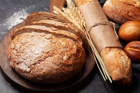 Various types of bread on stone tableの写真素材