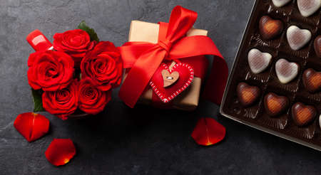 Rose flowers, Valentines day gift box and heart shaped chocolate box. Top view flat layの写真素材