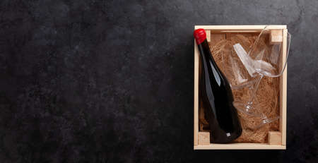 Red wine and glasses in wooden box. Top view flat lay with copy spaceの写真素材