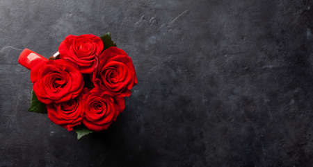 Rose flowers in coffee cup and petals. Valentines day greeting card with space for your greetings....