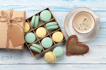 Homemade macaroons in gift box and coffee cup. Top view flat lay. Valentines dayの写真素材