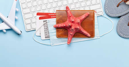 Travel and vacation concept. Trip accessories and items. Passport with tickets, keyboard and airplane toy. Top view flat layの写真素材