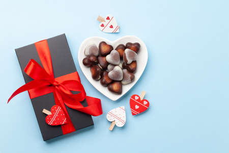 Valentines day heart shaped chocolate sweets, gift box and heart decor. Top view flat lay with copy...