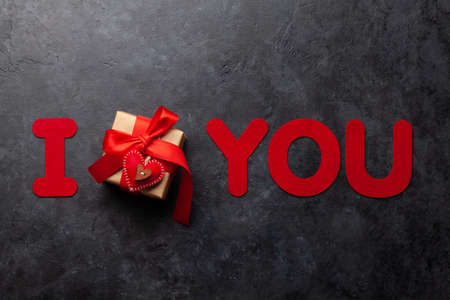 Valentines day gift box and I love you text on dark stone table. Top view flat lay with copy spaceの写真素材