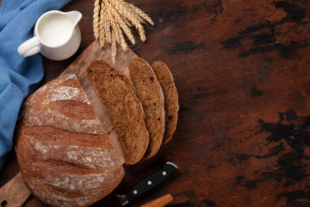 Homemade bread on wooden table. Flat lay with copy space