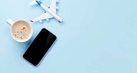 Travel and vacation concept. Trip accessories and items. Coffee cup, smartphone and airplane toy. Top view flat lay with copy spaceの写真素材