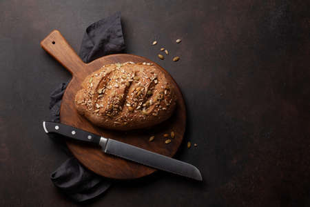 Homemade bread on wooden board. Flat lay with copy space