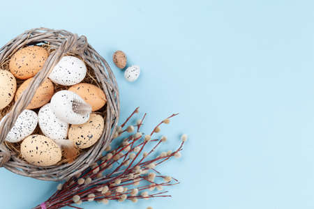 Easter greeting card with easter eggs and flowers. Top view flat lay with copy spaceの写真素材