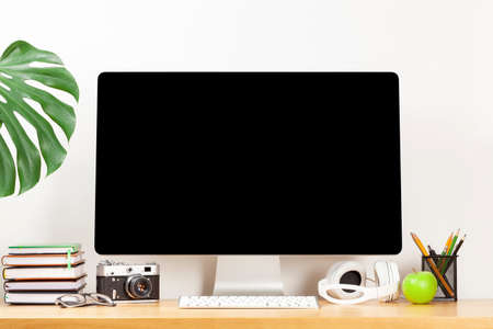 office desk workplace with blank screen pc and supplies