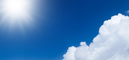 Blue sunny sky with clouds and copy space in centerの写真素材
