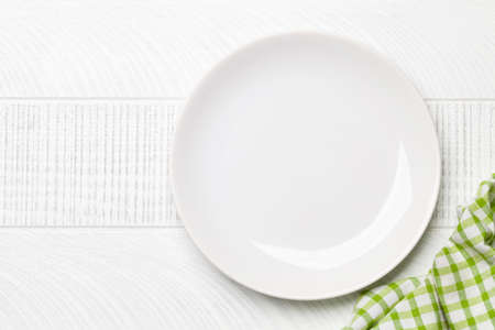 Empty plate on wooden table. Top view flat lay with copy space. Template or mockup for your meals