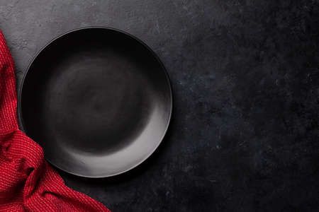 Empty plate and towel on stone table. Top view flat lay with copy space. Template or mockup for your mealsの写真素材