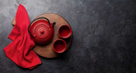 Tea cups and teapots on wooden board. Top view flat lay with copy spaceの写真素材