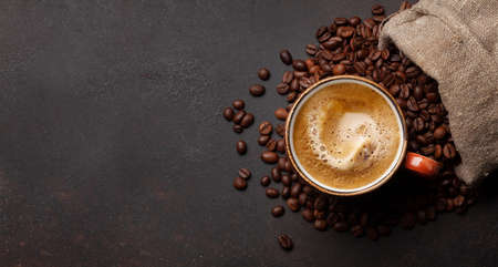 Fresh espresso coffee and roasted coffee beans in bag. Top view flat lay with copy space