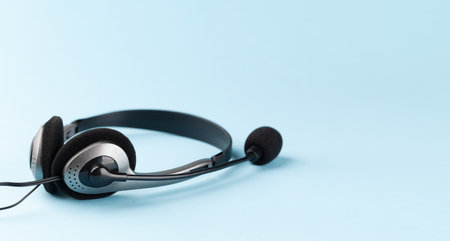 Headset on blue background with copy space. Template for service or supportの写真素材